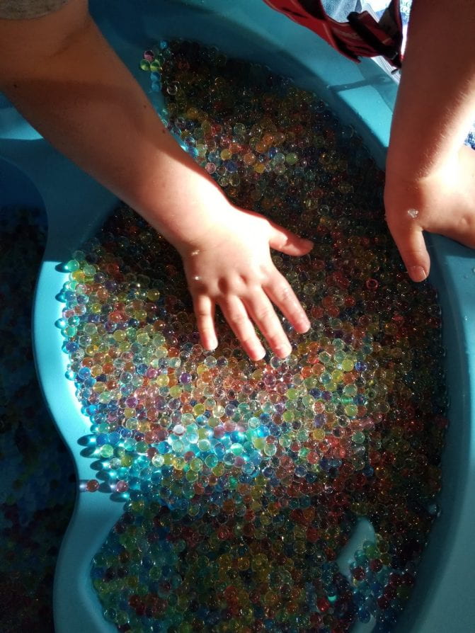 Children interacting with water beads