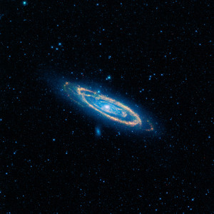 A false-color image of the mid-infrared emission from the Great Galaxy in Andromeda, as seen by Nasa's WISE space telescope.  The orange color represents emission from the heat of stars forming in the galaxy's spiral arms. The G-HAT team used images such as these to search 100,000 nearby galaxies for unusually large amounts of this mid-infrared emission that might arise from alien civilizations. Image Credit: NASA/JPL-Caltech/WISE Team 