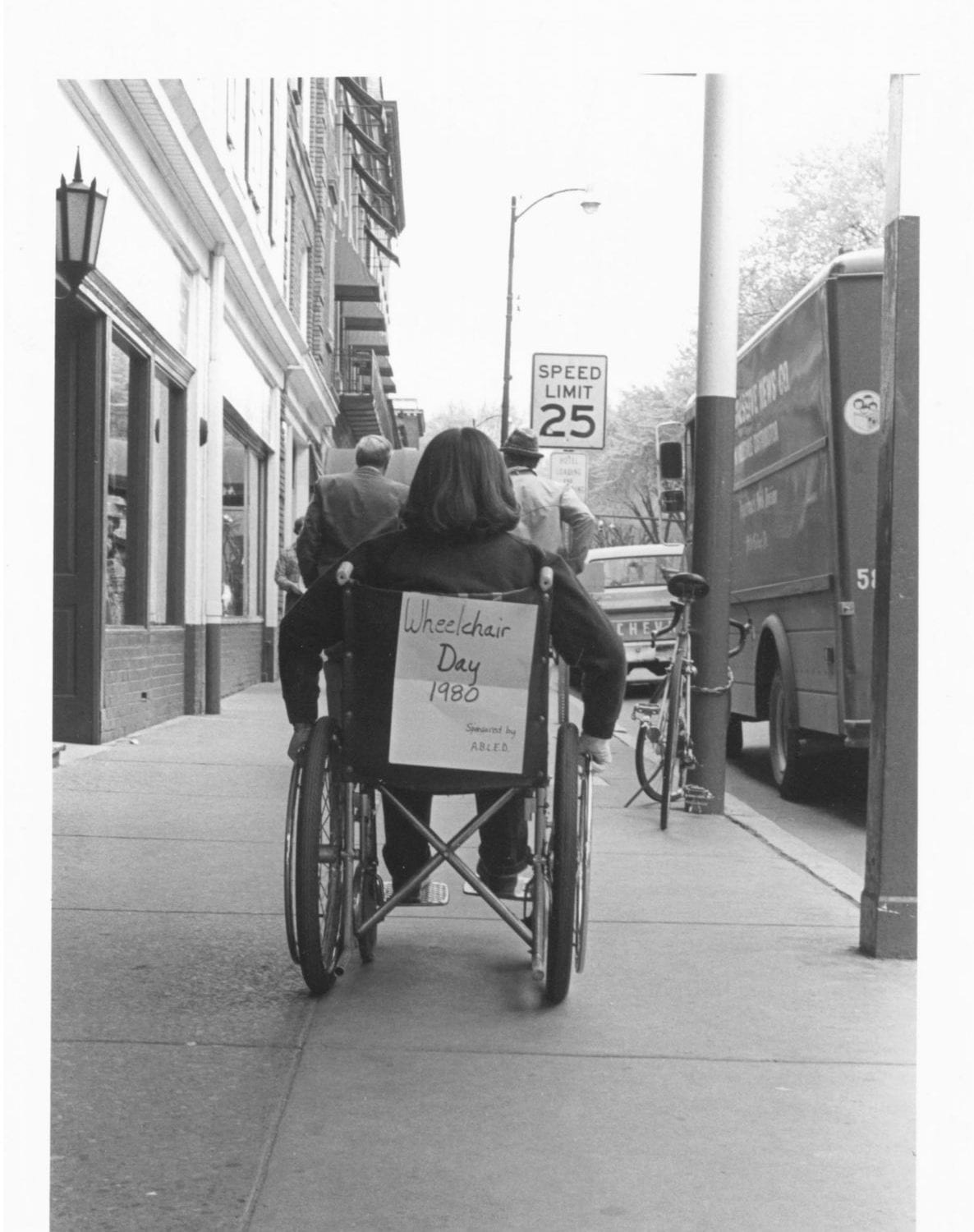 Black and white photograph of wheelchair from behind