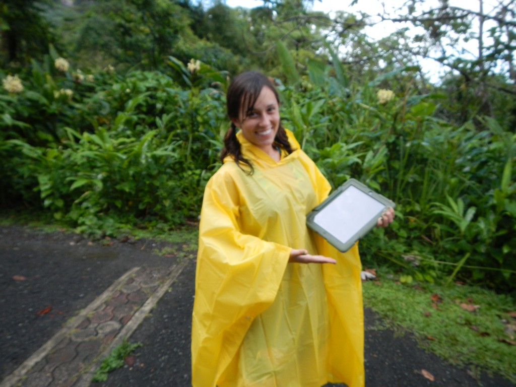 Danielle demonstrating the effectiveness of the waterproof cases protecting the iPads in the rainforest.