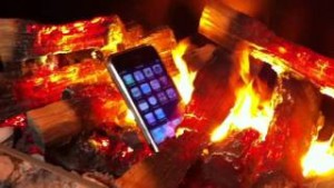 An iPhone sitting in the middle of a fire.