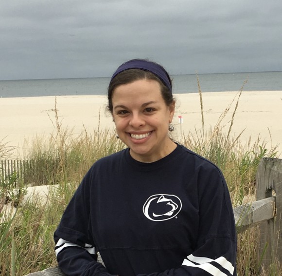 woman wearing Penn State clothing standing at the beach
