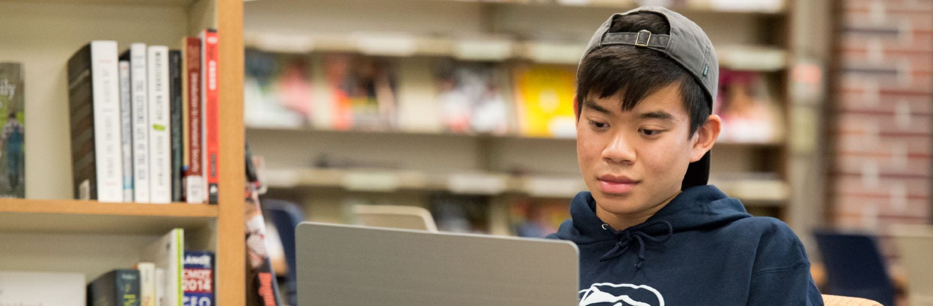 A student in a library looking at his computer