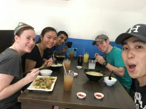 quynh and friends eating at a table