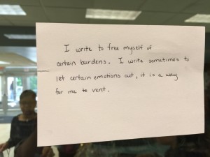 An index card taped to a wall outside Lubert Commons expressing one participant's feelings on the writing process.